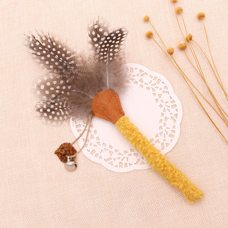 Yellow silvervine cat chew stick with feather and bell