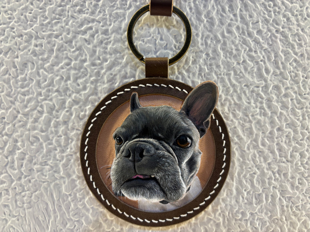 Custom French bulldog portrait leather keychain on a textured white background
