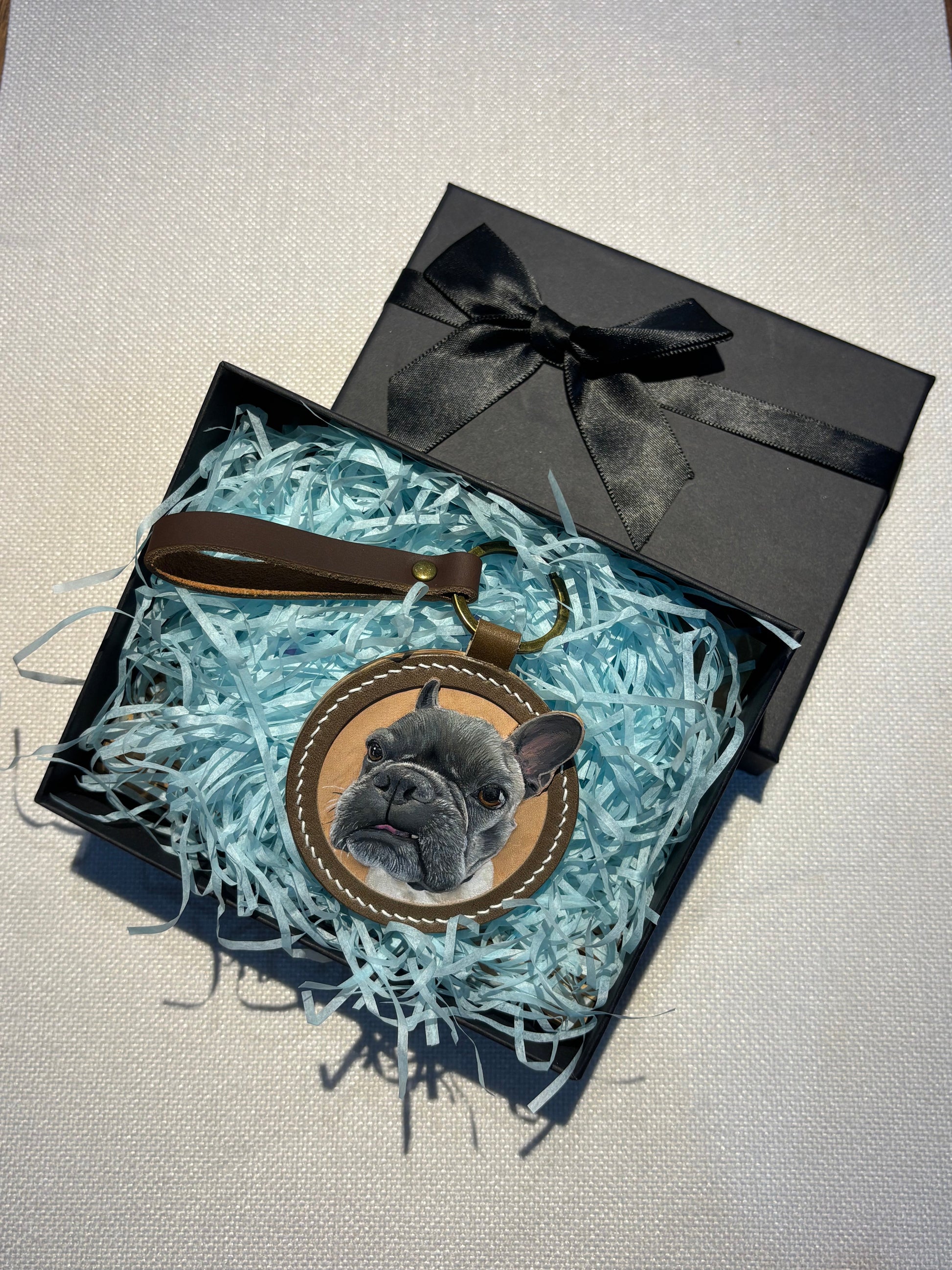 Custom dog portrait leather keychain presented inside a gift box