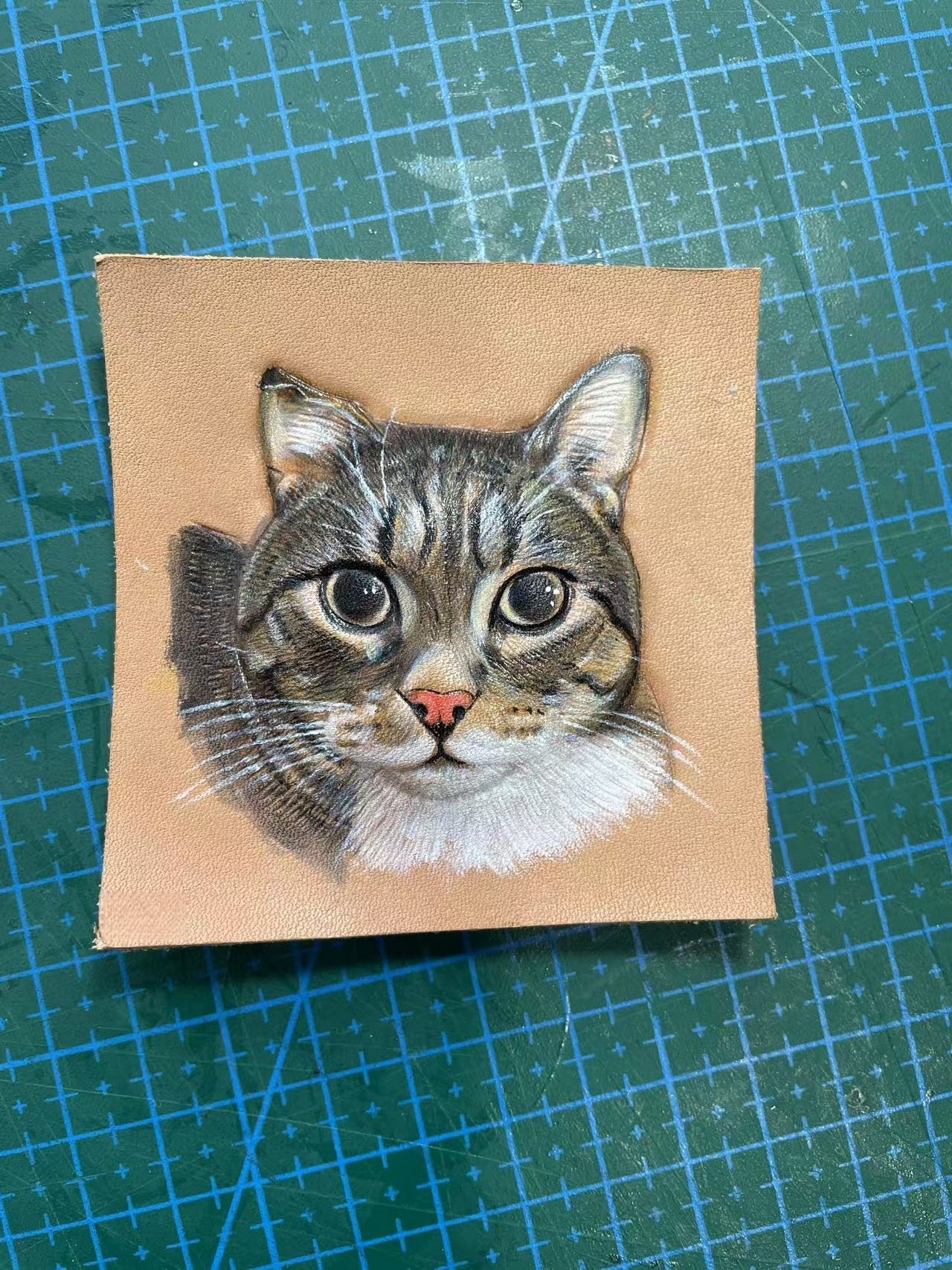 Hand-painted tabby cat portrait in progress on leather