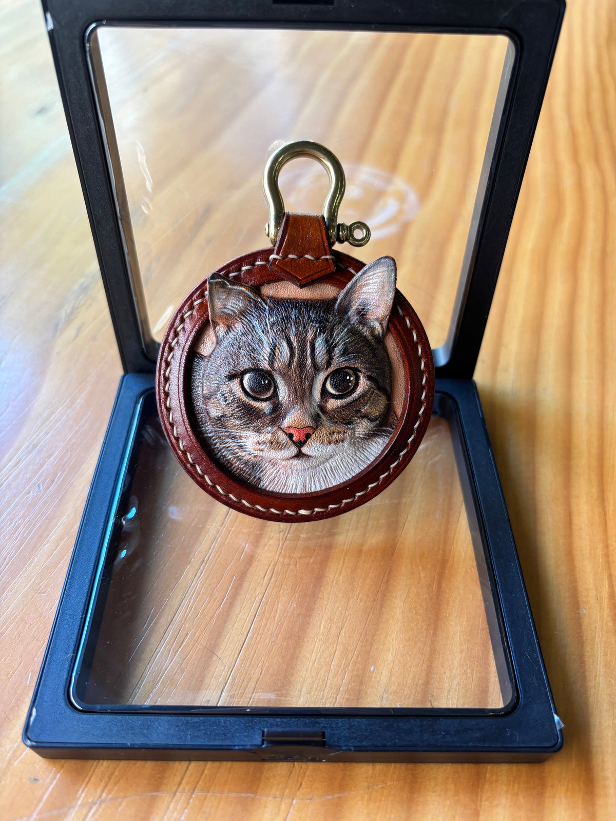 Finished custom cat portrait leather keychain displayed in a gift frame